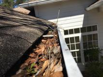 Before a completed gutter cleaning service project in the area